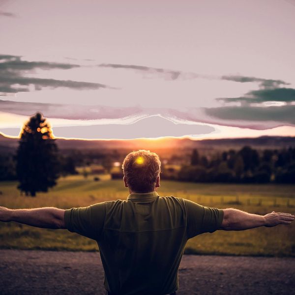 Man stretching outdoors at sunrise feeling refreshed and full of life.